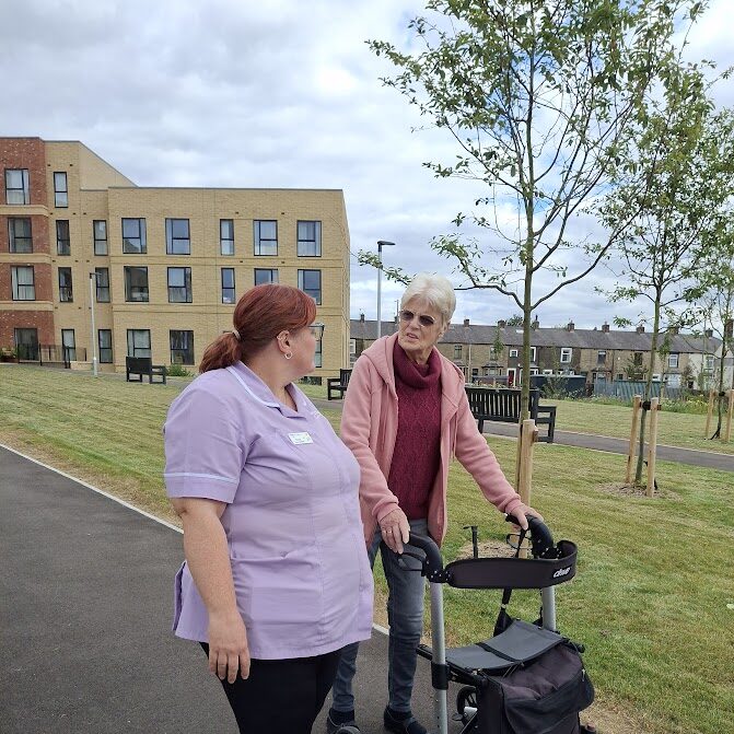 A resident going for a walk with a member of the support team